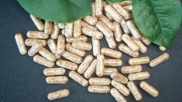 Herbal supplements being displayed with fresh green leaves video