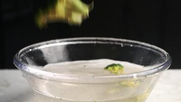 Broccoli splashes in water during cooking preparation video