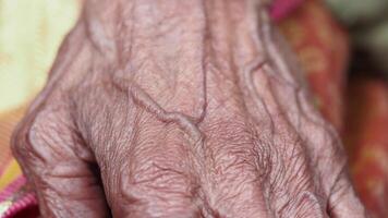 Elderly hand showcasing fine lines and wisdom in close-up video