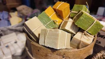 Handmade soap display at local market in vibrant colors video