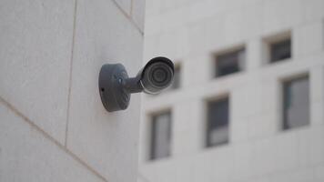 Security camera mounted on building capturing urban environment video