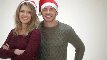Joyful couple in Santa hats share laughter and warmth video