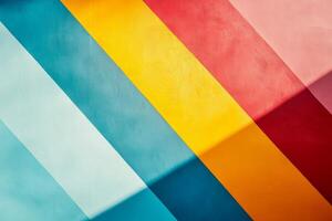 A vibrant wall is painted with diagonal stripes in colors including blue yellow red orange and pink photo