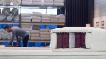 Man selecting a cozy orthopedic bed and mattress in a stylish furniture store video
