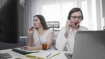 Dynamic duo of female call center agents engaged in customer support video