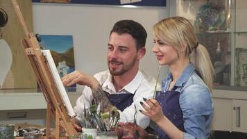Joyful couple creating art together on a romantic date at the Art Studio video
