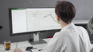 Confident female stock trader smiling at the camera while analyzing market data video