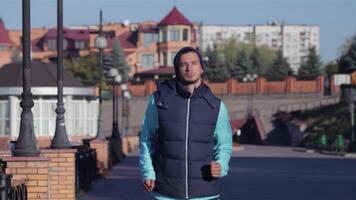 Dedicated male runner enjoying an invigorating jog in an urban setting video