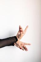 Graceful hand poses of caucasian female with red nails and black sheer sleeve photo