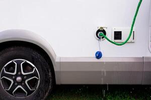 Campervan water hose connection with dripping tap close up photo
