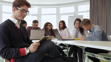 Dynamic young managers collaborating in a bright office space video