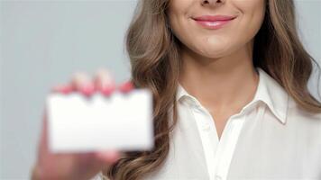 Charming woman showcasing a blank card with a confident smile video