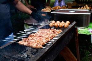 Tasty shish kebab cooking process. Grilled meat on fair. photo