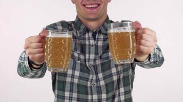 A joyful man beams with excitement, holding out two frosty beer mugs filled with golden brew, inviting you to join the celebration. This vibrant scene captures the spirit of Oktoberfest, radiating warmth and camaraderie, perfect for any festive gathering video
