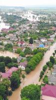 Aerial View from above on the flooded houses and the city. Flood after floods from the mountains. The houses are flooded with dirty water of the flooded river video