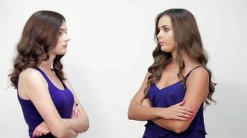 Two angry sisters confront their scared sibling, showcasing a dramatic family conflict against a stark white background. The tension is palpable as emotions run high, highlighting the struggle between anger and fear in this intense sibling dynamic video