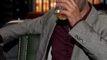 Charming mature man enjoying whiskey with a confident smile video