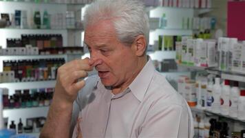 Senior male customer appears unwell at the drugstore video