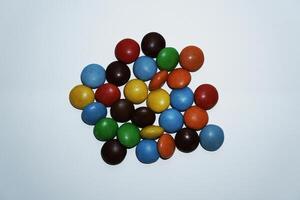 Colorful round dots candies isolated on white background photo
