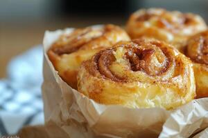 A close up of some cinnamon rolls in a paper basket photo