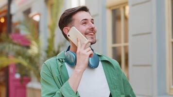 Man tourist having remote conversation communicate speaking by smartphone with friend good news video
