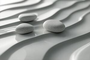 Three white stones on a white surface photo
