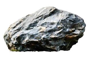 A large grey boulder rests on a patch of green grass photo