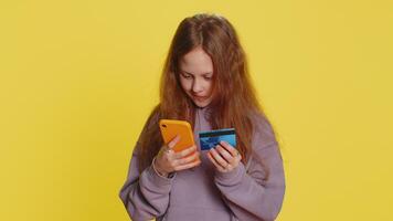 Child girl use credit bank card smartphone while transferring spend money purchases online shopping video