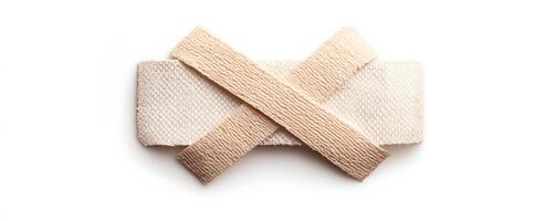 Beige bandage strips crossed on a flat surface photo
