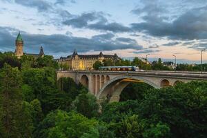 Scenery of Adolphe Bridge and the clock tower in Luxembourg city, Luxembourg at dusk photo