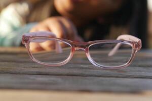 Glasses resting on a wooden table in soft afternoon light photo