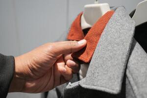 Exploring the texture of a stylish collar in a clothing store photo