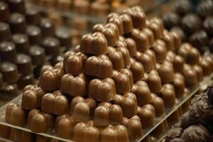 Chocolate candies arranged in decorative pyramid shape in store photo