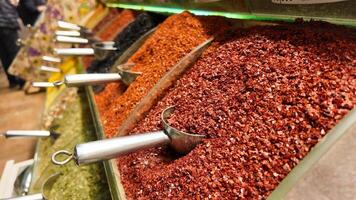 Colorful spices displayed in jars at local market in vibrant setting photo