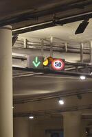 Traffic signals indicating speed limit and lane direction in a tunnel photo