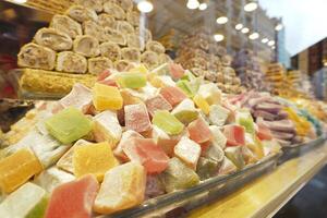 Colorful display of traditional sweets in an open market setting photo