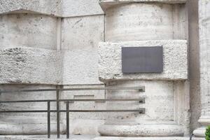 Historic building entrance with textured stone and handrails photo