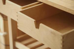 Wooden drawer partially opened in a minimalist workspace photo