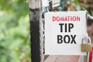 Community donation tip box inviting support for local initiatives photo