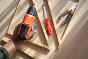 Working with tools to build a wooden project in a workshop photo