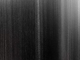 Brushed Dark Metal Texture with Reflection - Abstract Black and Gray Metallic Surface with Vertical Grain Highlight photo