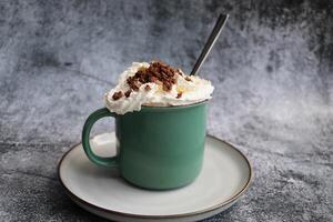 Iced caramel latte topped with whipped cream and caramel sauce, refreshing and sweet coffee drink photo