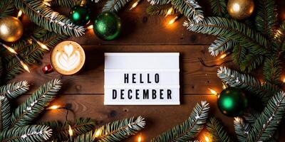 Hello december - christmas decorations on wooden background photo