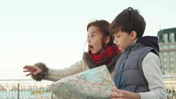 Excited school boy and girl discover a hidden gem with their map video