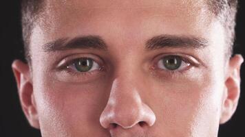 Close-up of a handsome young man transitioning from surprise to a warm smile video