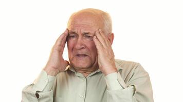Senior man experiencing intense headache while rubbing his temples video