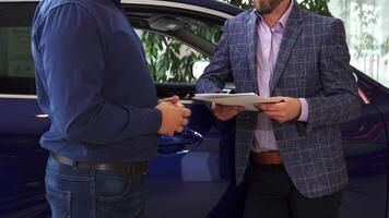 Men finalize the agreement with a handshake to confirm the car transaction video