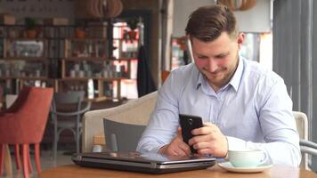 Businessman engaged in a phone conversation at a cozy cafe video