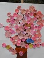 Messages of Support and Love for Japan, Displayed as a Cherry Blossom Tree. A large display, shaped like a cherry blossom tree, is adorned with numerous small, folded paper notes. photo
