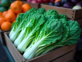 Harvested sea kale piled in a wooden crate at a farmer's market, rustic setting, autumn day photo